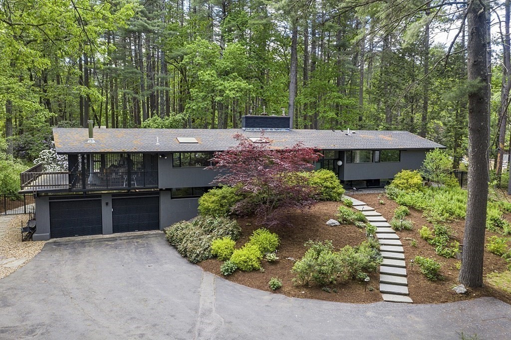 127 Commerford Road Concord, MA 01742 - Photo 33 of 33 a view of a house with a yard and lawn chair under an umbrella