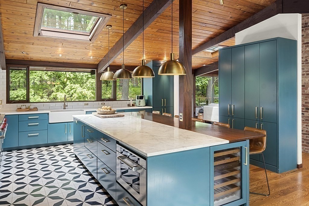 127 Commerford Road Concord, MA 01742 - Photo 7 of 33 a large kitchen with kitchen island a sink stainless steel appliances and a large window