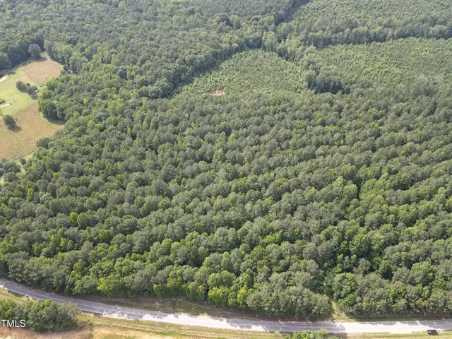 a view of a field of grass and trees