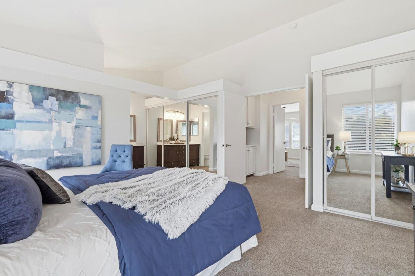 283 Perch Way Aptos, CA 95003 - Photo 22 of 37 a spacious bedroom with a large bed and a chandelier