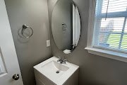 4557 Ivy Patch Drive Fortson, GA 31808 - Photo 12 of 27 a bathroom with a sink and mirror with window