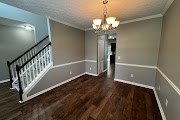 4557 Ivy Patch Drive Fortson, GA 31808 - Photo 13 of 27 a view of a room with wooden floor and staircase
