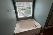 4557 Ivy Patch Drive Fortson, GA 31808 - Photo 17 of 27 a bath tub sitting in a bathroom next to a window