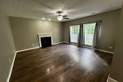 4557 Ivy Patch Drive Fortson, GA 31808 - Photo 2 of 27 wooden floor in an empty room with a fireplace