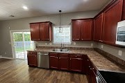 4557 Ivy Patch Drive Fortson, GA 31808 - Photo 6 of 27 a kitchen with stainless steel appliances granite countertop wooden cabinets a stove top oven a sink and dishwasher