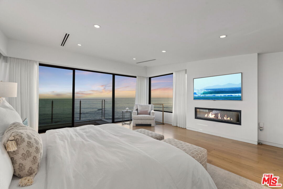 24146 Malibu Road Malibu, CA 90265 - Photo 13 of 26 a bedroom with a large bed and a large window