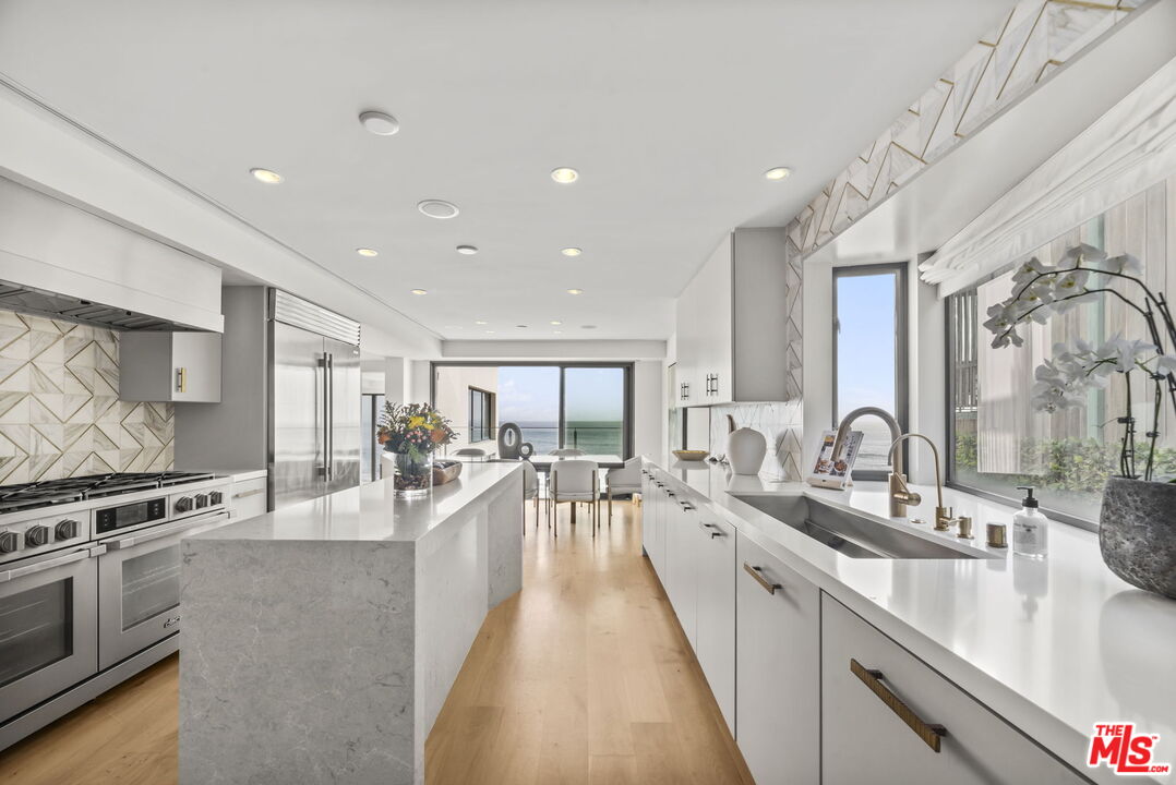 24146 Malibu Road Malibu, CA 90265 - Photo 8 of 26 a large kitchen with stainless steel appliances lots of counter space and windows