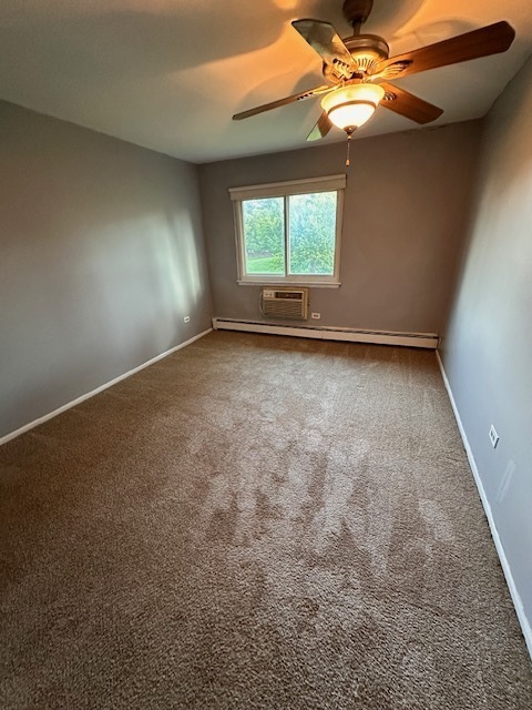 745 Hill Drive, Unit 314 Hoffman Estates, IL 60169 - Photo 6 of 8 an empty room with windows and fan