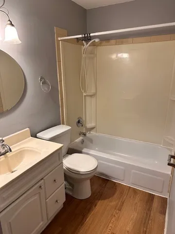 a bathroom with a double vanity sink toilet mirror and shower