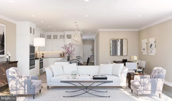 a living room with furniture and view of kitchen