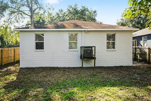 a view of a backyard with a tree