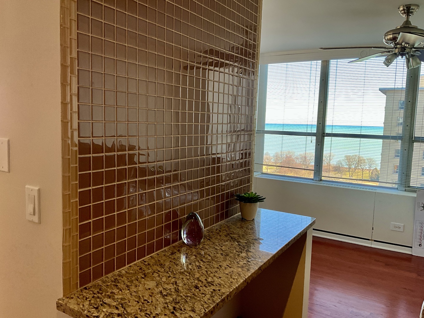 655 West Irving Park Road, Unit 2110 Chicago, IL 60613 - Photo 16 of 38 a bathroom with a granite countertop sink a toilet and window
