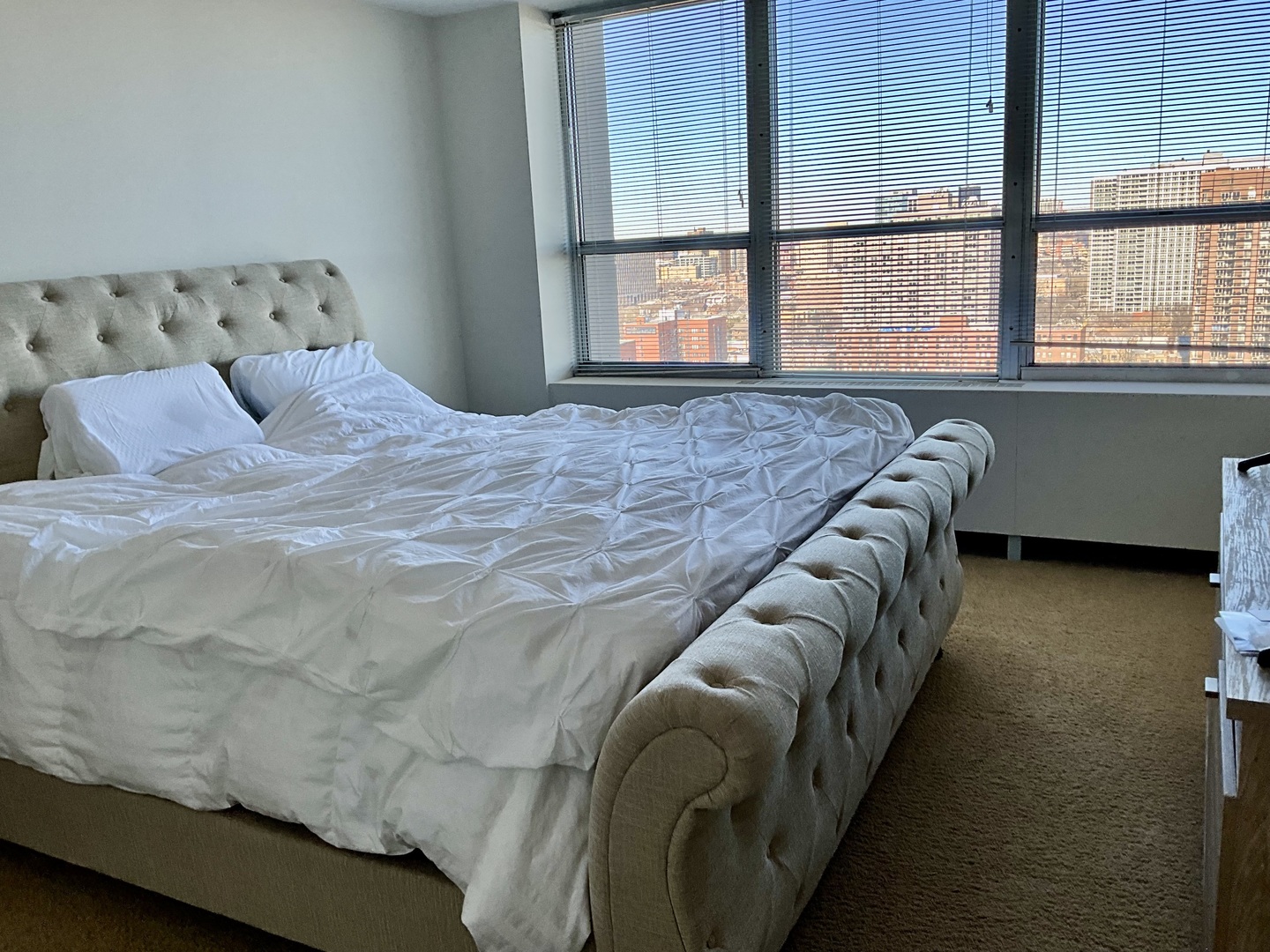 655 West Irving Park Road, Unit 2110 Chicago, IL 60613 - Photo 22 of 38 a bed sitting in a bedroom next to a window