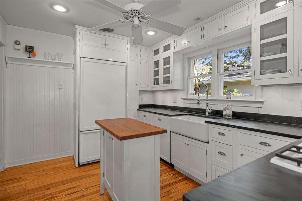 637 Scotland Street Dunedin, FL 34698 - Photo 11 of 72 a kitchen with stainless steel appliances granite countertop a sink and a refrigerator