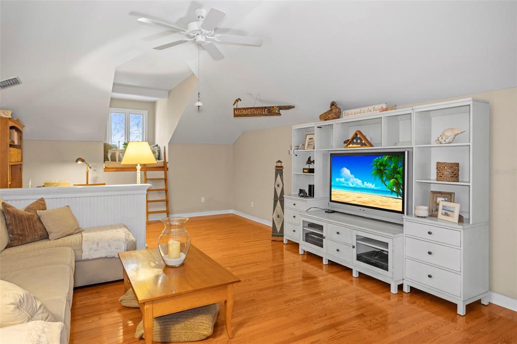 637 Scotland Street Dunedin, FL 34698 - Photo 18 of 72 a living room with furniture and a flat screen tv