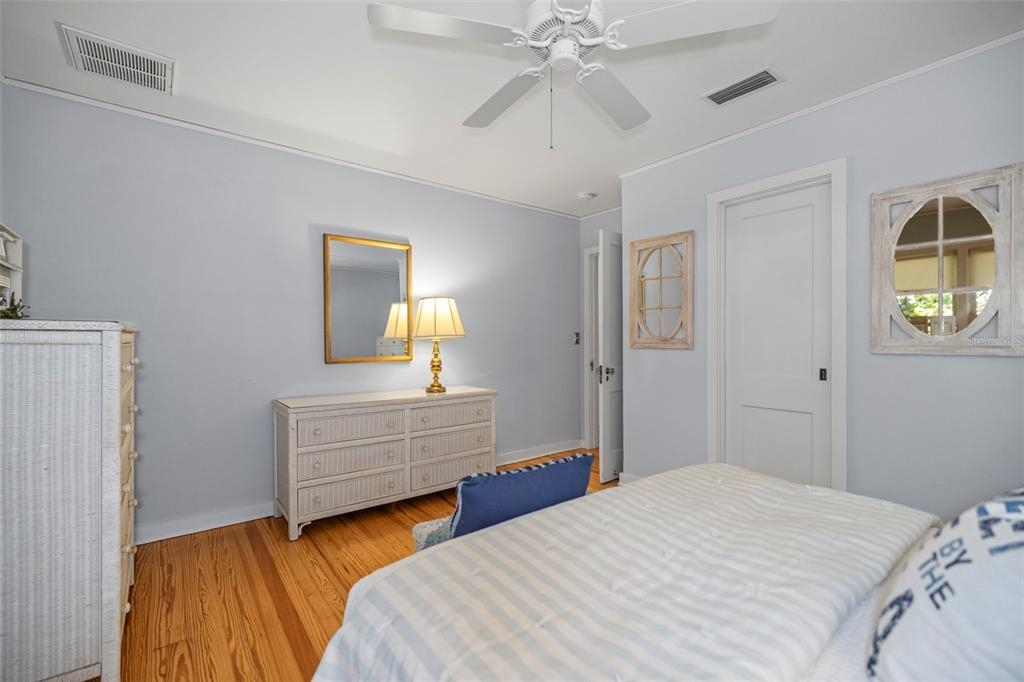 637 Scotland Street Dunedin, FL 34698 - Photo 22 of 72 a bedroom with a bed and a chandelier