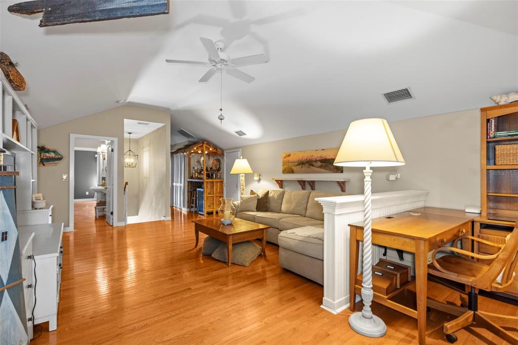 637 Scotland Street Dunedin, FL 34698 - Photo 34 of 72 a living room with furniture a chandelier and a table