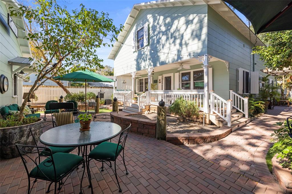637 Scotland Street Dunedin, FL 34698 - Photo 41 of 72 a backyard of a house with table and chairs