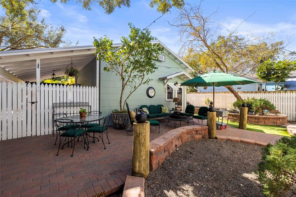 637 Scotland Street Dunedin, FL 34698 - Photo 69 of 72 a view of a patio with a table and chairs under an umbrella