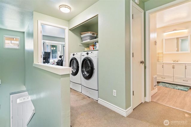 a view of a storage & utility room with a washer dryer