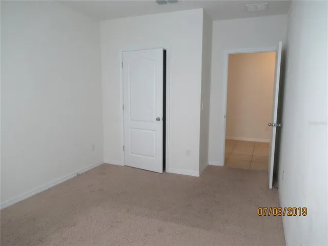 a view of empty room with windows