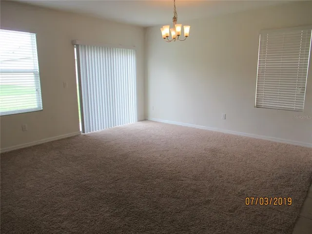 a kitchen with a refrigerator and a stove top oven