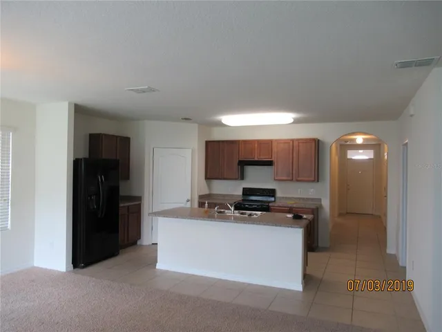 a large white kitchen with cabinets and stainless steel appliances