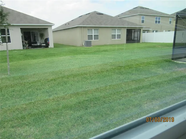 a view of a house with a back yard