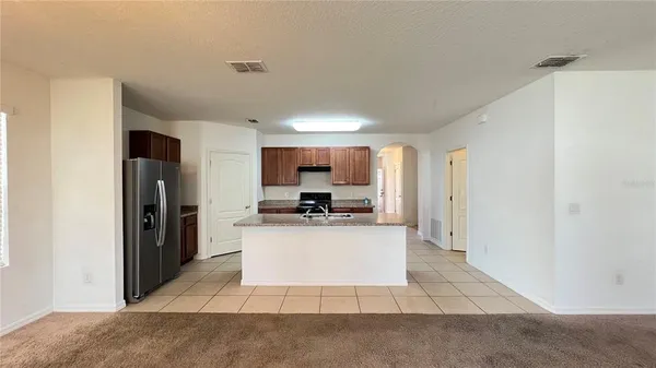 a view of kitchen with refrigerator sink and stove