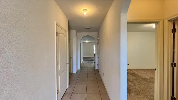 a view of a hallway with wooden shelves
