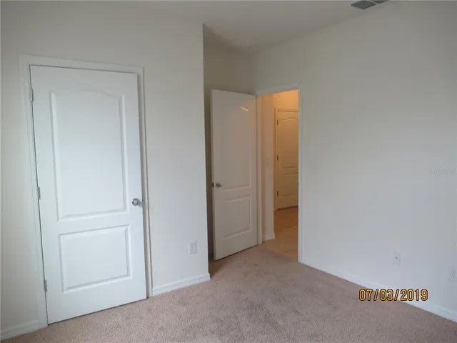 a bathroom with a granite countertop bathtub shower sink vanity and toilet