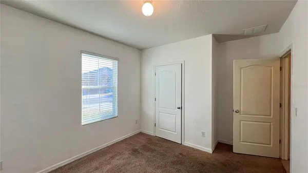 an empty room with windows closet and windows