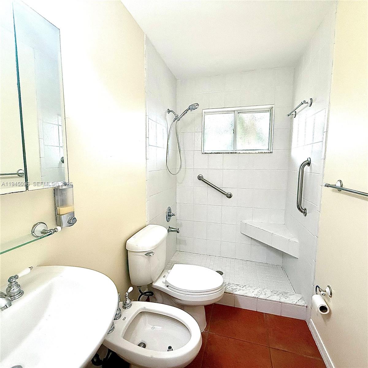 11900 Southwest 6th Street, Unit 2 Miami, FL 33144 - Photo 14 of 14 a bathroom with a granite countertop toilet a sink and a mirror