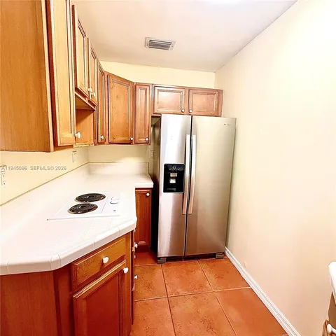 a kitchen with a refrigerator and a sink