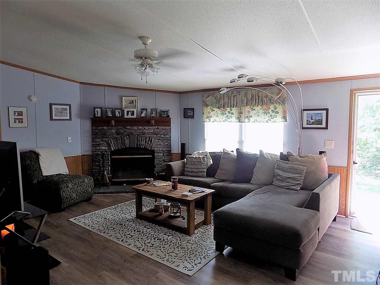 7204 Cedar Tree Street Willow Spring, NC 27592 - Photo 3 of 25 a living room with furniture and a fireplace