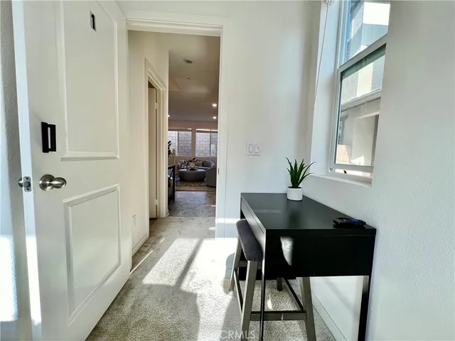 a view of a room with furniture and wooden floor