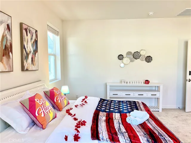 a bedroom with a bed and a couch