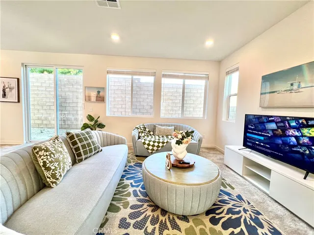 a living room with furniture and a large window