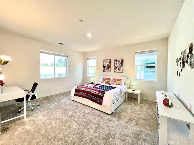 a living room with a bed and a window