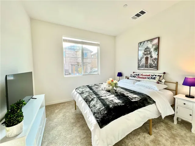 a bed sitting in a bedroom next to a window