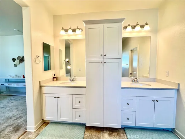 a bathroom with a double vanity sink mirror and