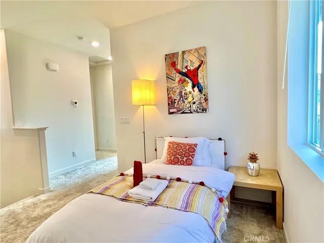 a bedroom with a bed and a painting on the wall