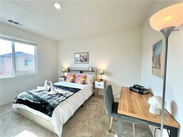 a bed room with a bed and a chair