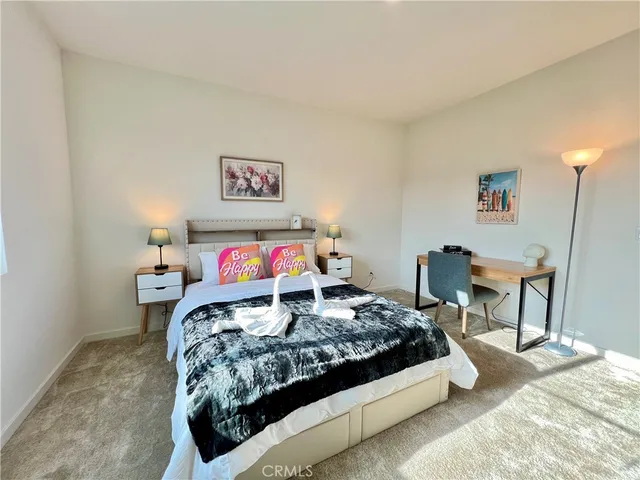 a bedroom with a bed and a table in it