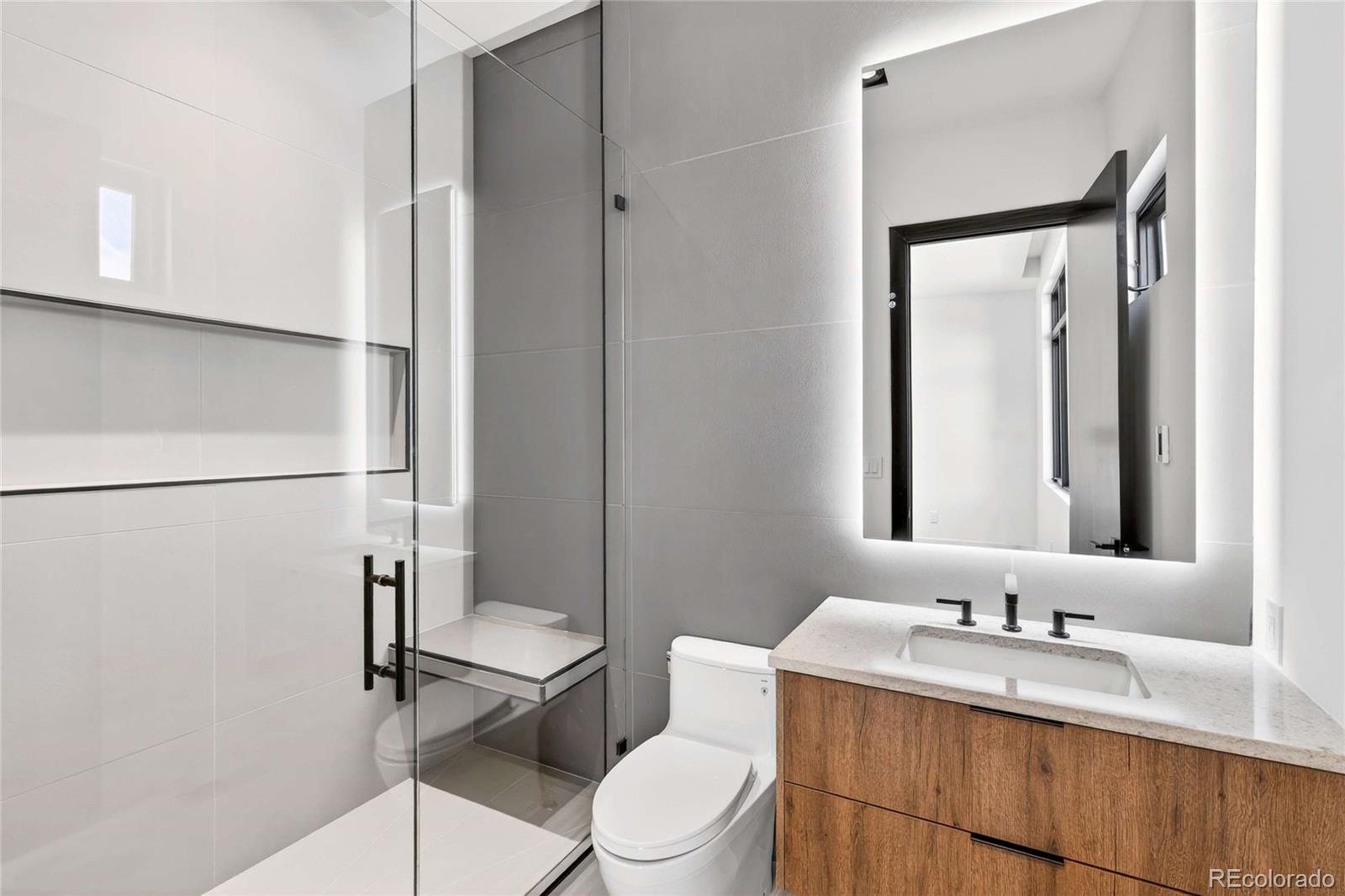 545 Strada Rossa Road Golden, CO 80401 - Photo 11 of 49 a bathroom with a granite countertop toilet sink and mirror