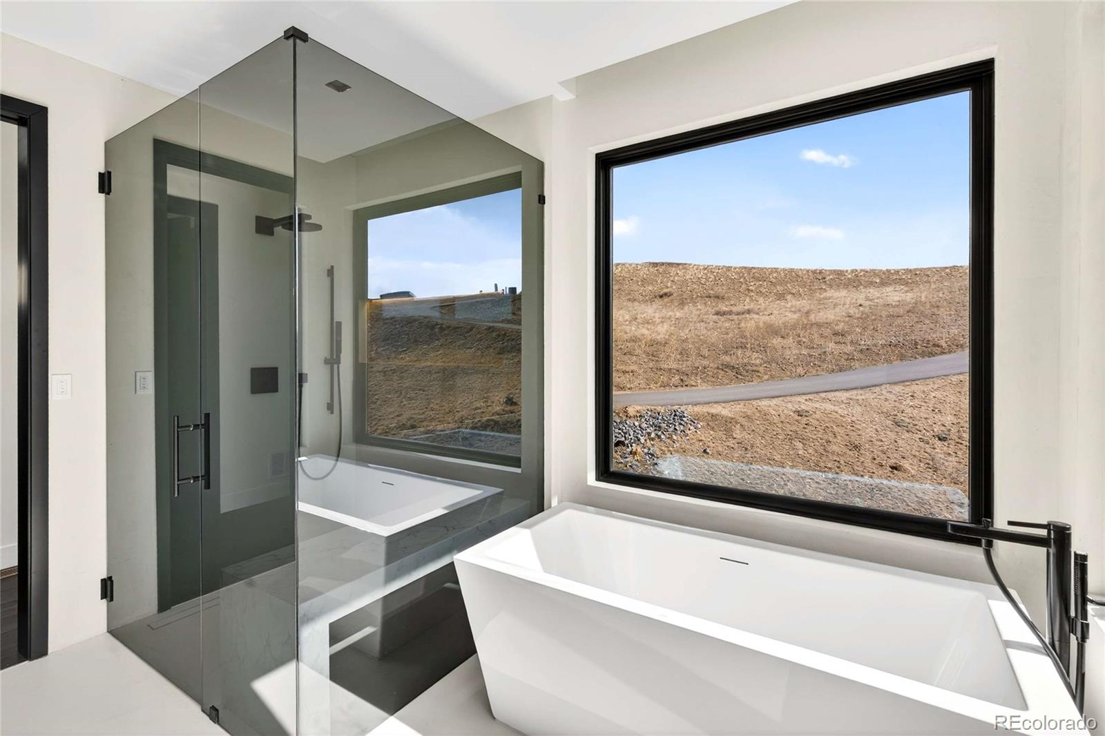 545 Strada Rossa Road Golden, CO 80401 - Photo 17 of 49 a bathroom with a bathtub and a shower