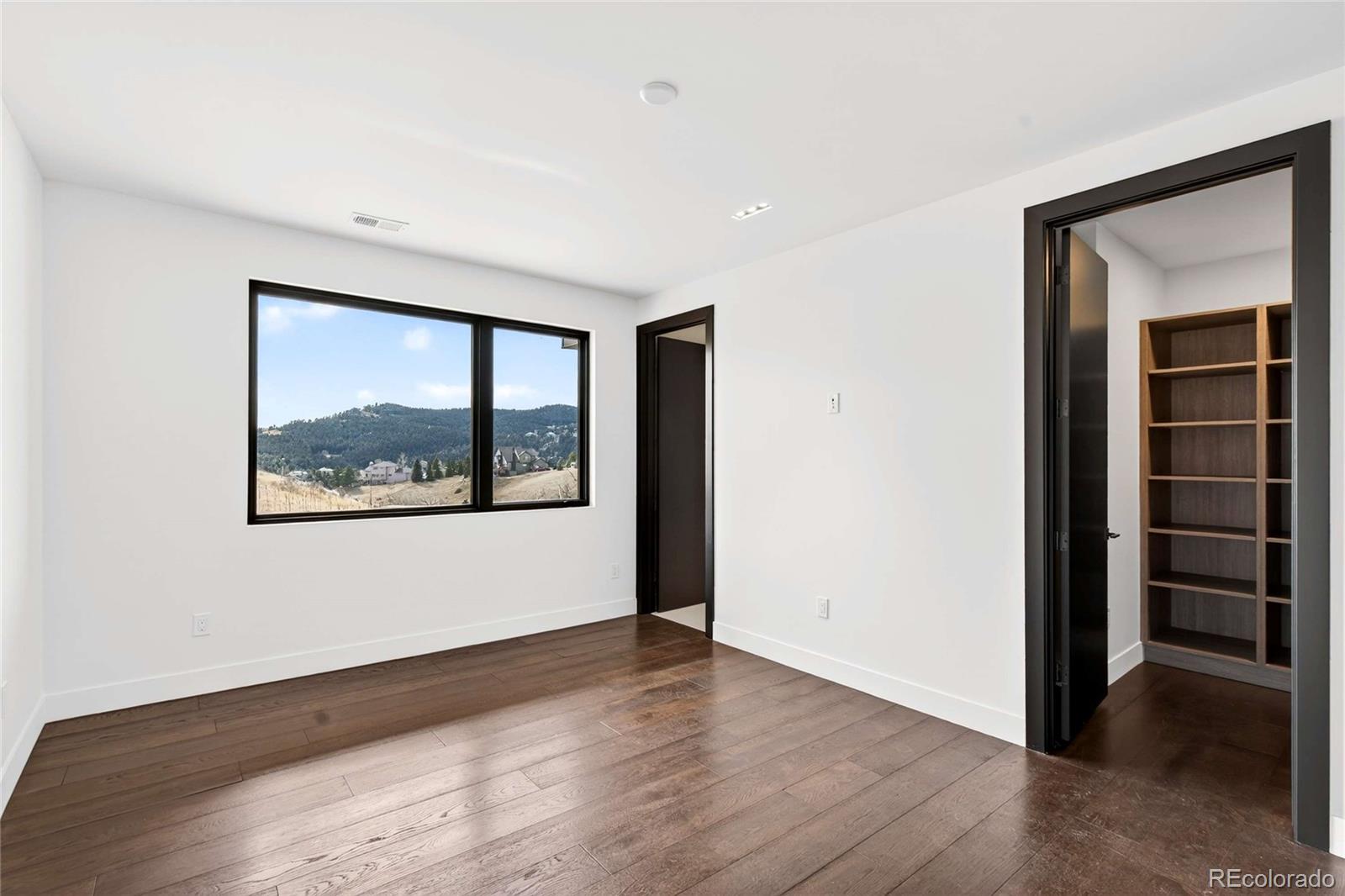 545 Strada Rossa Road Golden, CO 80401 - Photo 22 of 49 an empty room with a window