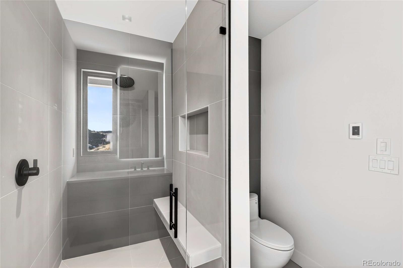545 Strada Rossa Road Golden, CO 80401 - Photo 24 of 49 a white toilet sitting next to a bathroom sink
