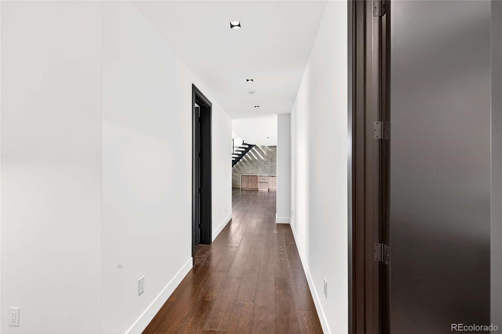 545 Strada Rossa Road Golden, CO 80401 - Photo 26 of 49 a view of a hallway with wooden floor and a bathroom