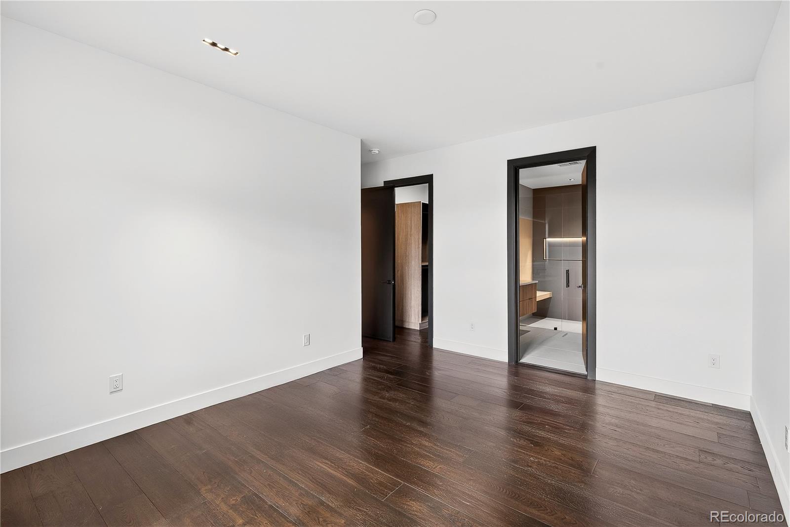 545 Strada Rossa Road Golden, CO 80401 - Photo 35 of 49 a view of an empty room with wooden floor and closet